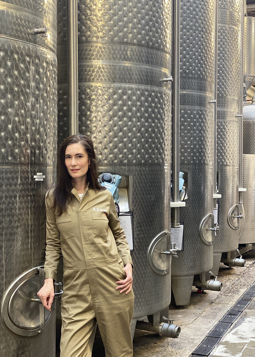 Dr. Sonat Birnecker Hart in jumpsuit in front of fermenters