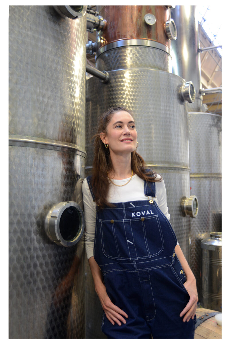 Dr. Sonat Birnecker Hart wearing KOVAL overalls in front of fermenters